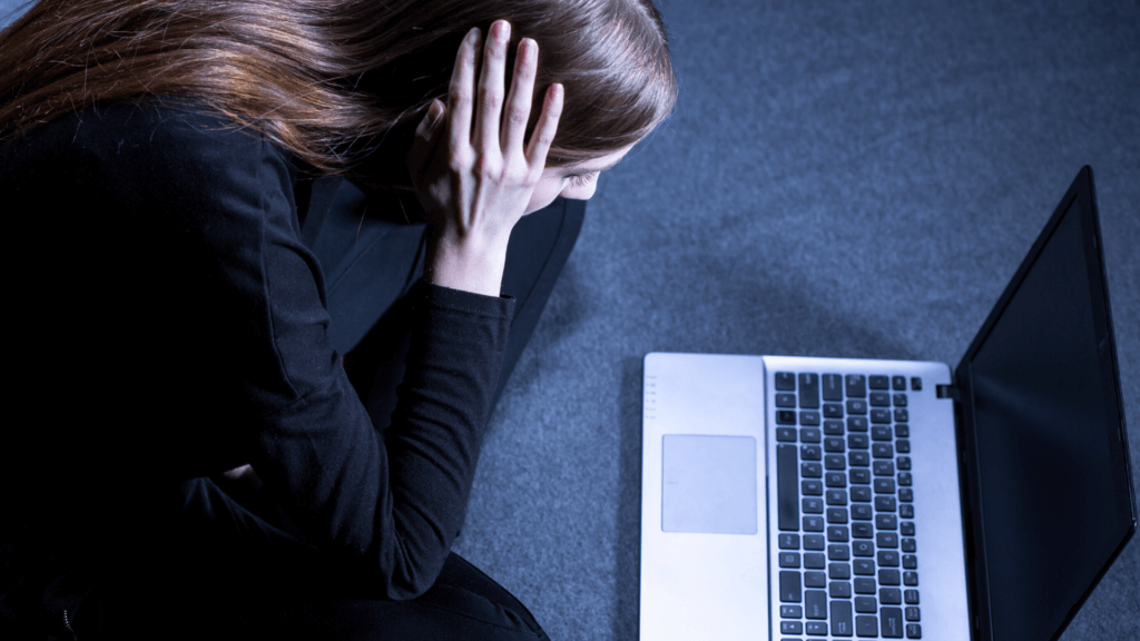 woman sitting in front of a laptop worried because the website no longer runs Flash.