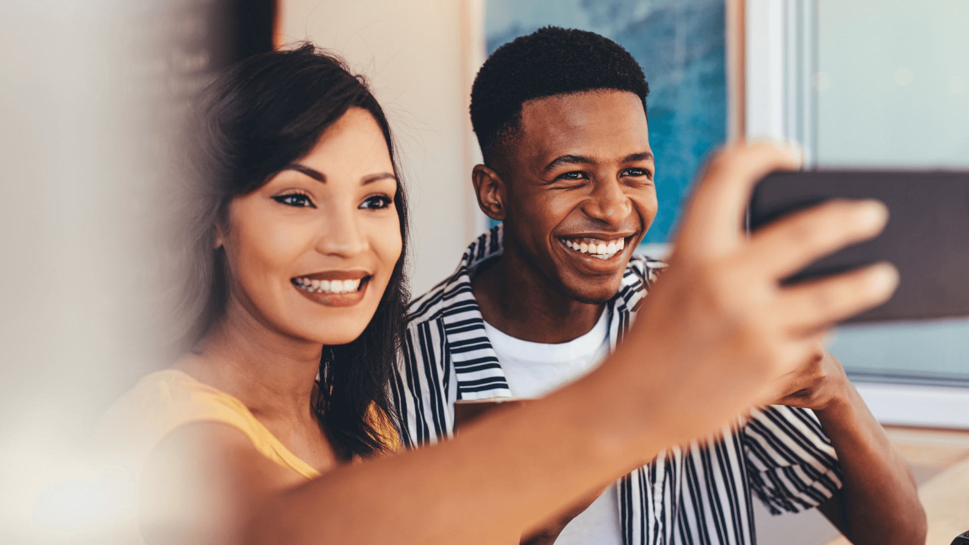 Two people smiling for a selfie creating content for their blog